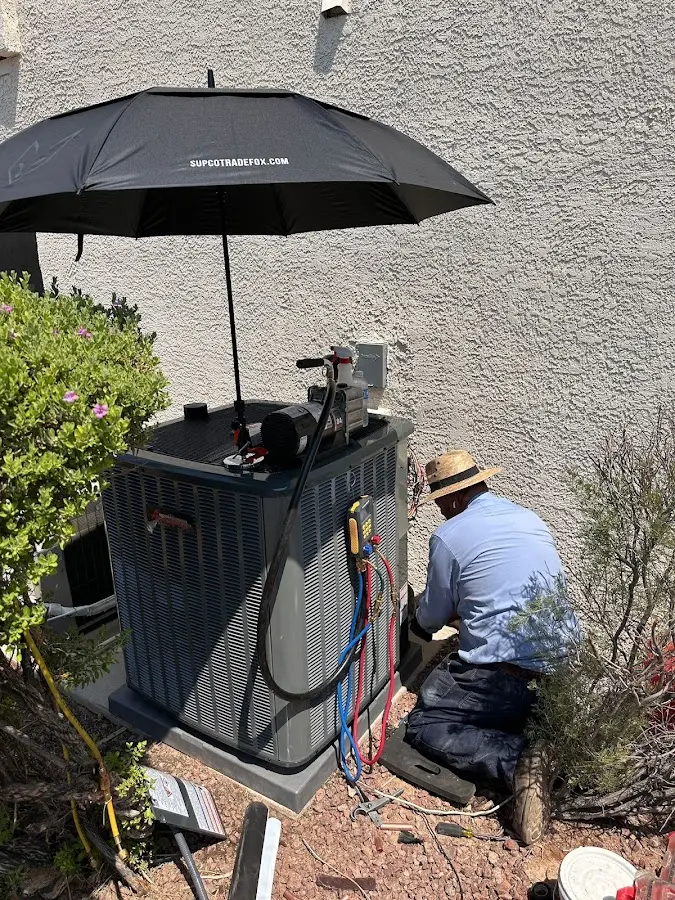 HVAC technician performing outdoor AC maintenance in Miami Lakes